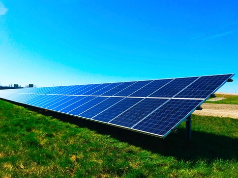 row of solar panels on a field of grass